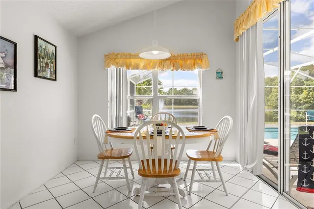 a dining room with furniture a chandelier and wooden floor