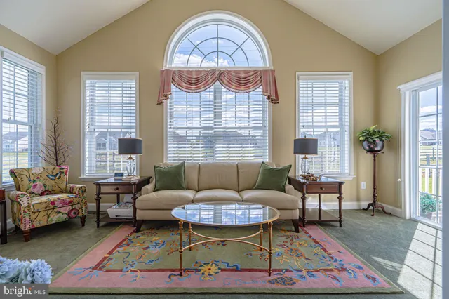 a spacious bedroom with a bed mirror and window