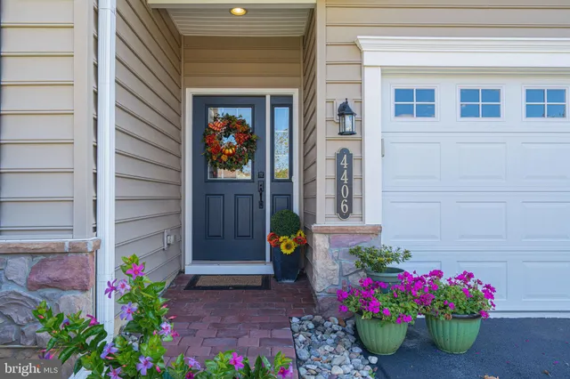 a front view of a house with a yard and tree s