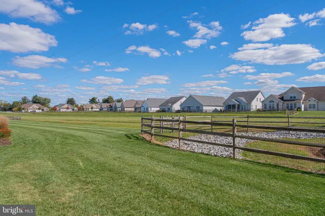 an aerial view of residential houses with outdoor space and river