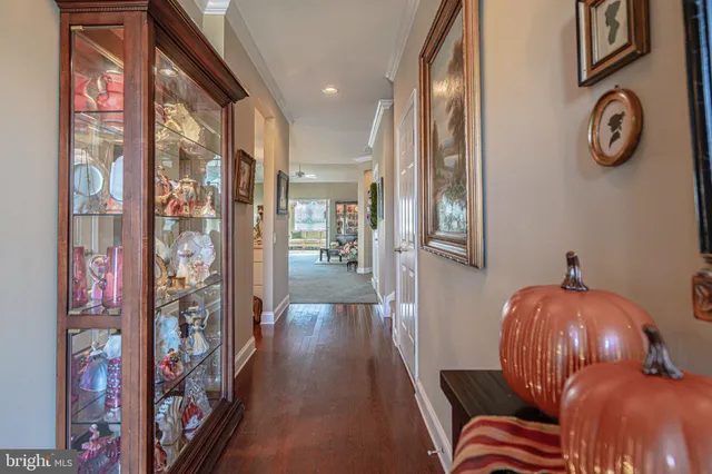 a view of a hallway with wooden floor and stairs
