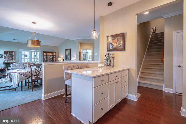 a living room with fireplace furniture and a large window
