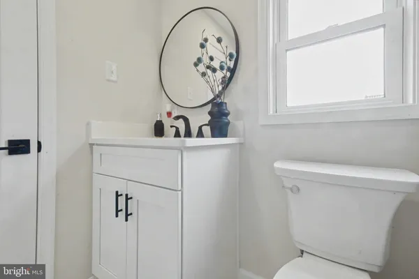 a bathroom with a toilet a sink and a mirror