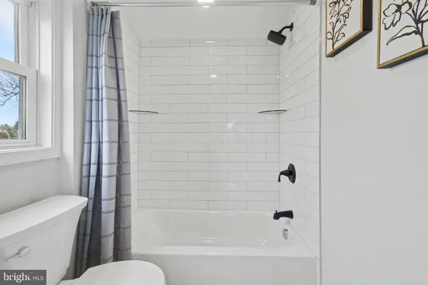 a bathroom with a bathtub and shower