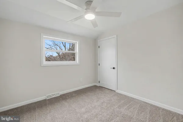 an empty room with a fan
