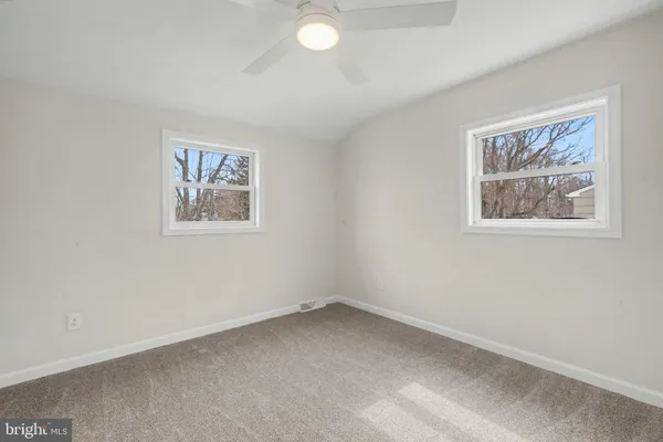 an empty room with a painting on the wall