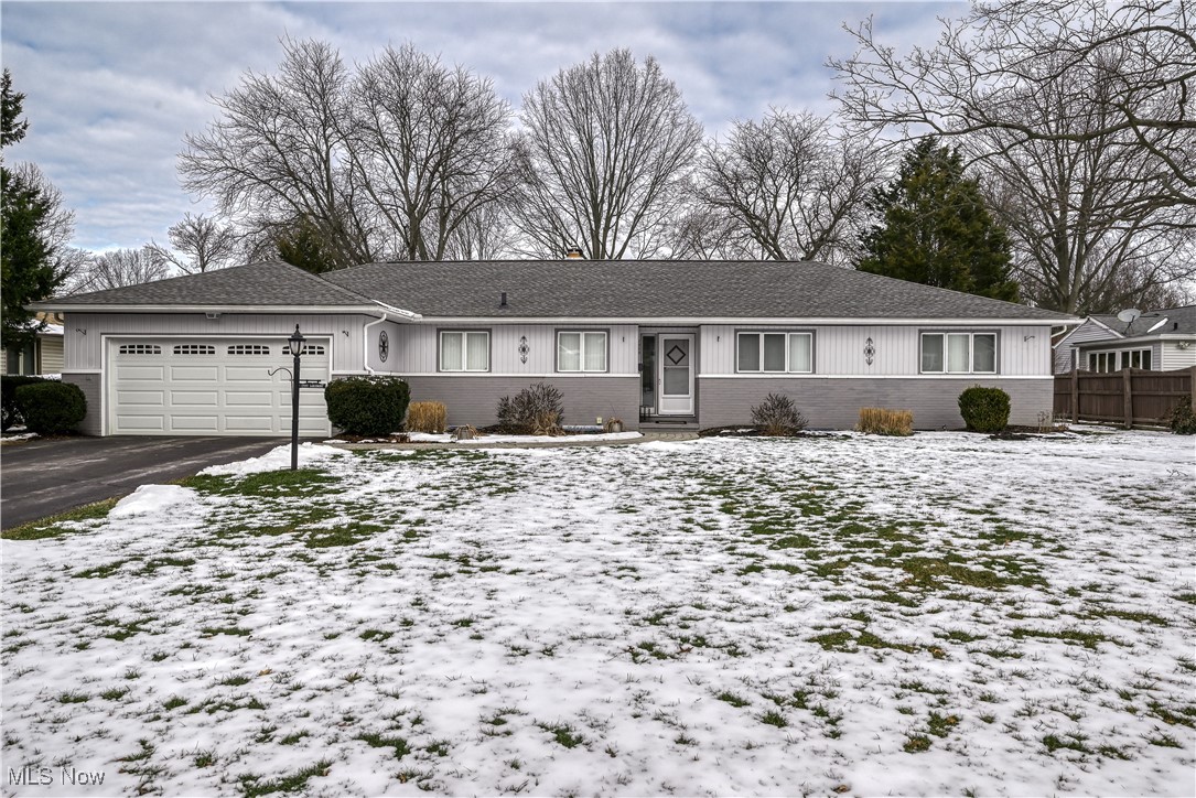 1989 Larchmont Road Akron, OH 44313 - Photo 1 of 38 Ranch-style house with aphalt driveway, brick siding, a shingled roof, fence, and a garage