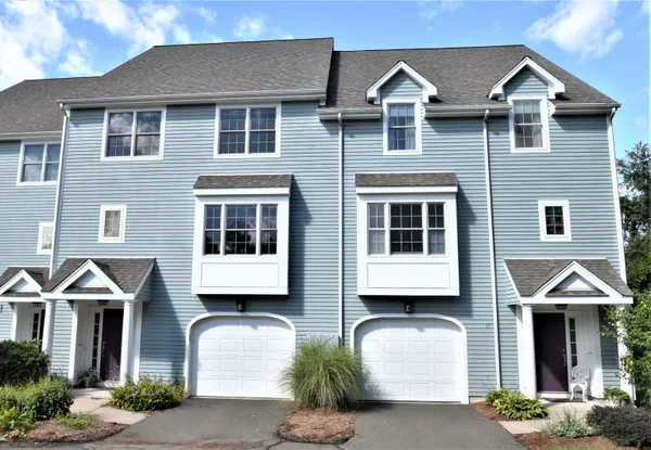 a front view of a house with a yard and balcony