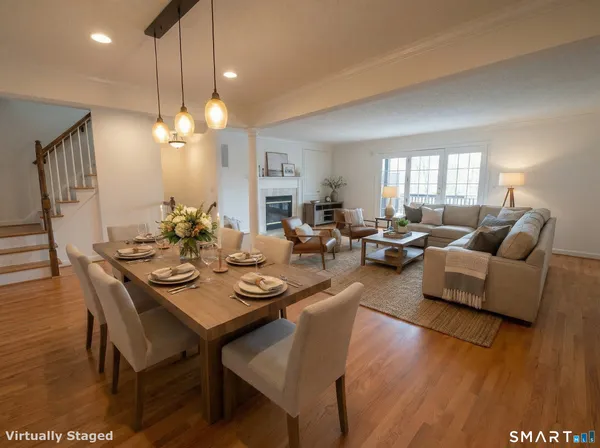 a view of a dining room with furniture and wooden floor