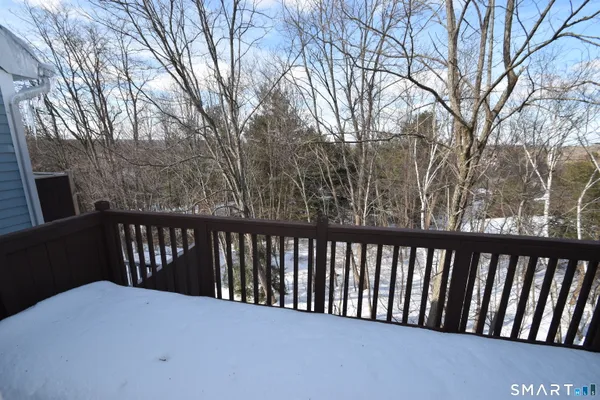 a balcony with wooden floor and fence