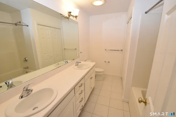 a bathroom with a sink a mirror and a shower