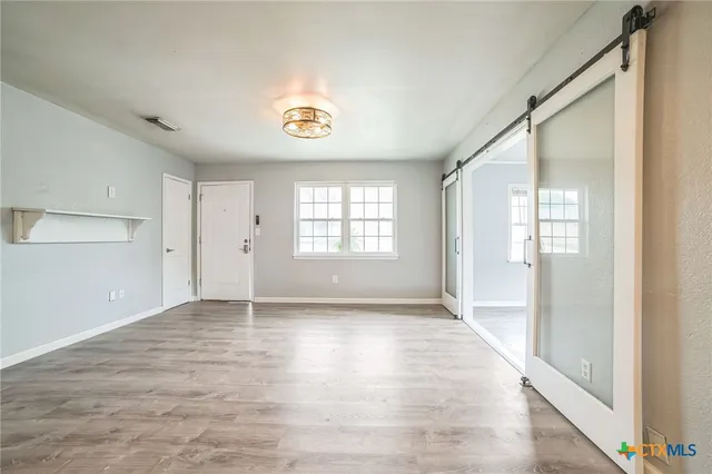 a view of an empty room with a window