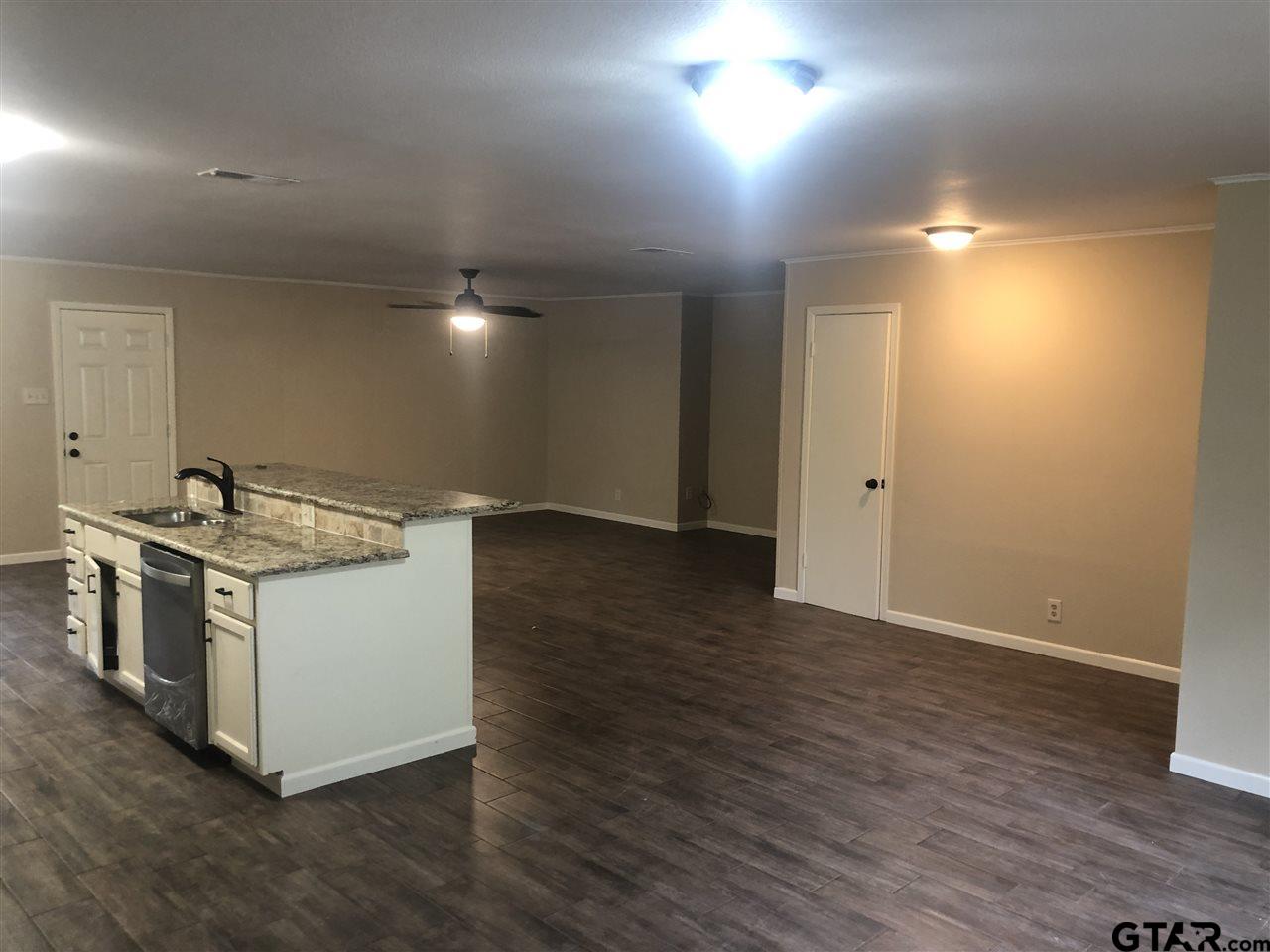 3001 South Robertson Avenue Tyler, TX 75701 - Photo 3 of 12 a kitchen with a sink and stove