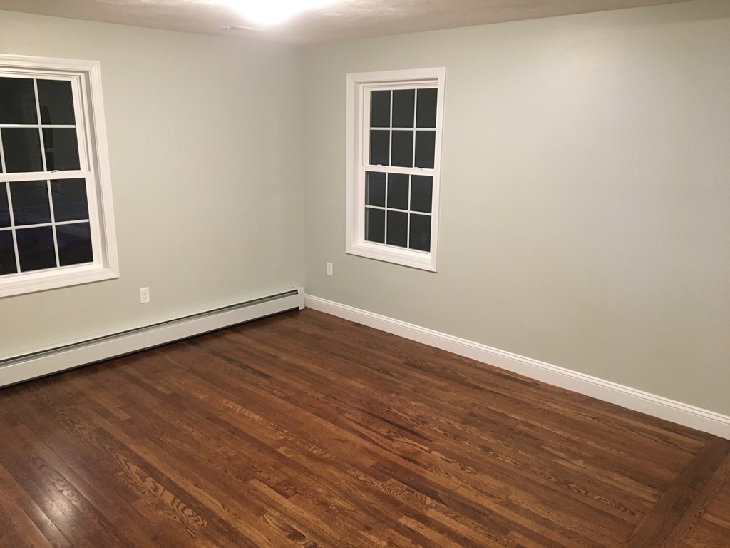 75 Baldwin Road Billerica, MA 01821 - Photo 14 of 30 an empty room with wooden floor and windows