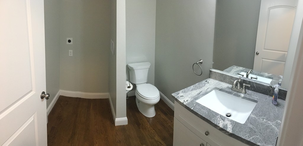 75 Baldwin Road Billerica, MA 01821 - Photo 25 of 30 a bathroom with a granite countertop sink a toilet and a mirror