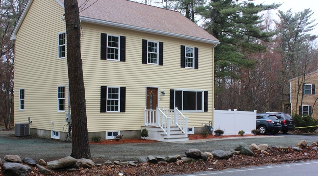 75 Baldwin Road Billerica, MA 01821 - Photo 3 of 30 a view of a white house with large windows next to a road