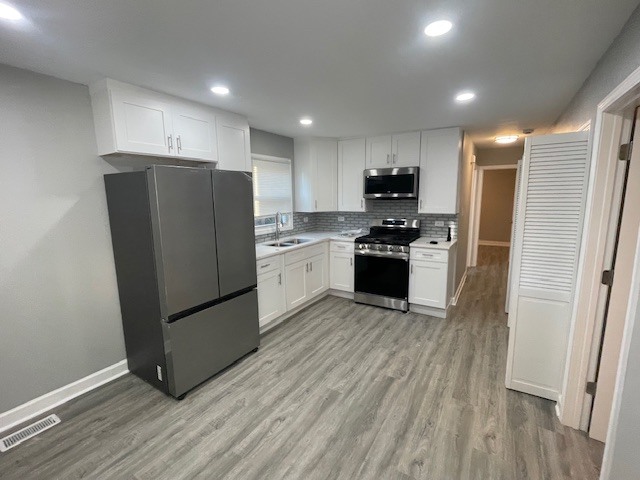 432 West Hickory Street, Unit 2 Chicago Heights, IL 60411 - Photo 4 of 10 a kitchen with stainless steel appliances granite countertop a refrigerator and a stove top oven