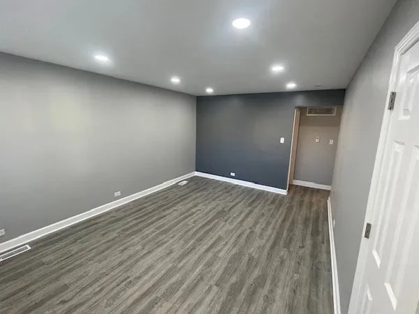 a view of room with wooden floor