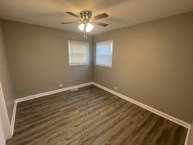 432 West Hickory Street, Unit 2 Chicago Heights, IL 60411 - Photo 9 of 10 a view of an empty room with wooden floor and a chandelier fan
