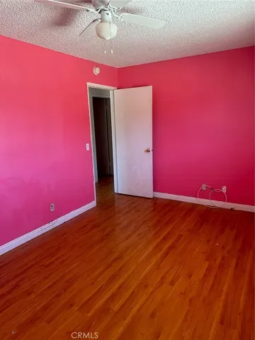 a bathroom with a granite countertop bathtub sink vanity mirror and toilet
