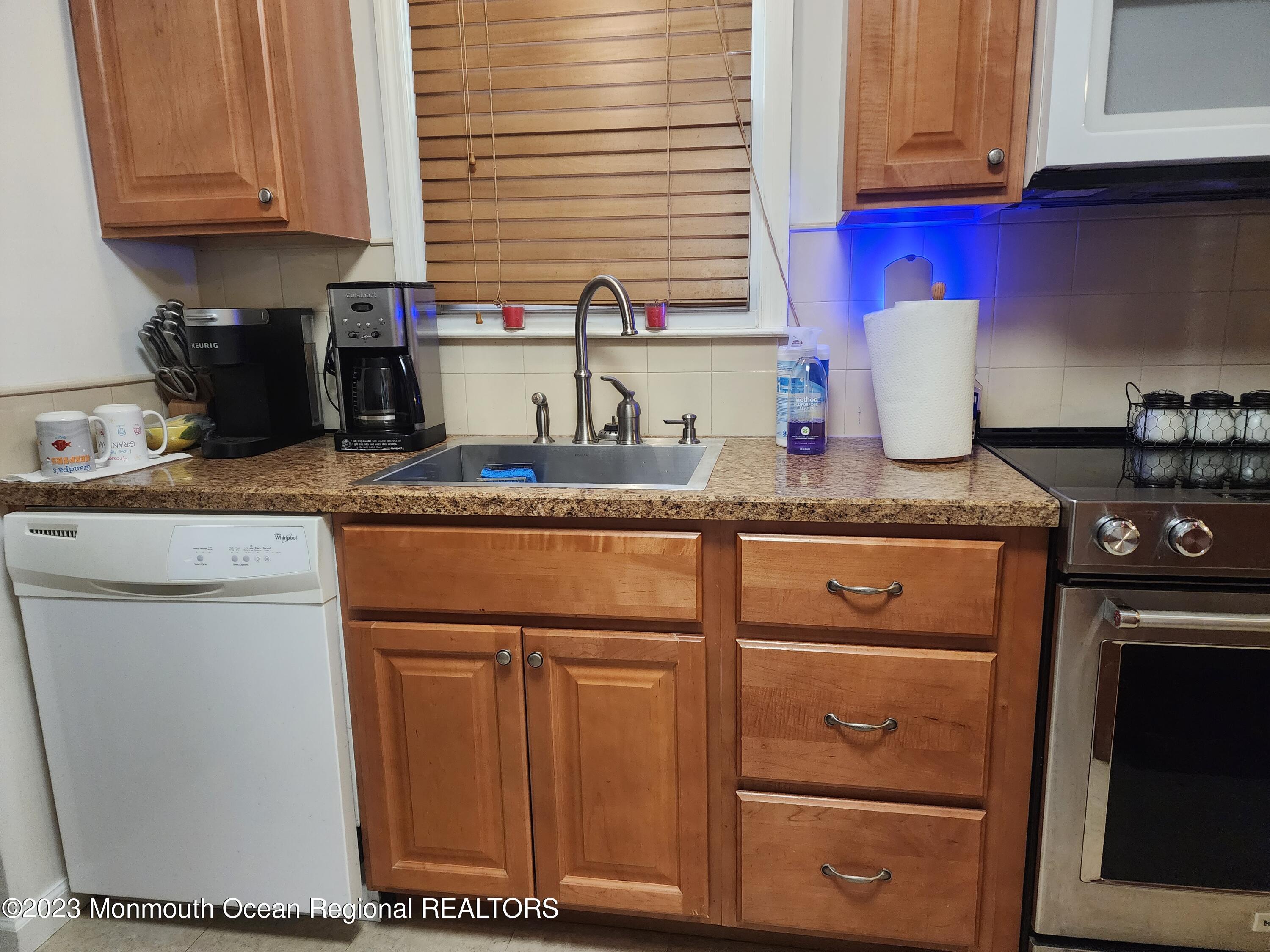 35 Hartford Road Whiting, NJ 08759 - Photo 26 of 47 a kitchen with stainless steel appliances granite countertop a sink stove and cabinets