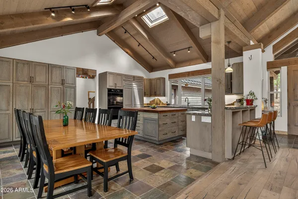 a dining room with furniture and wooden floor