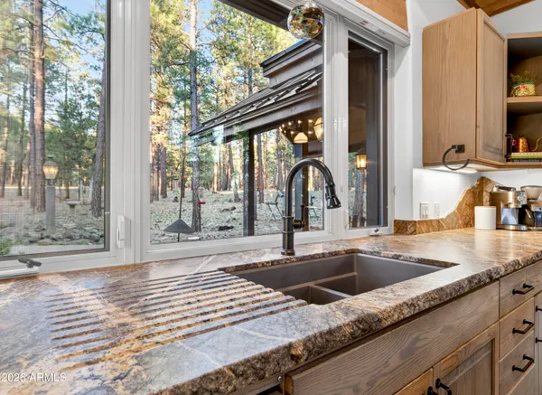 a view of a sink a table and chairs in the patio