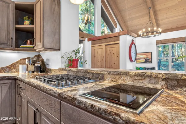 a kitchen with a stove a sink and a window
