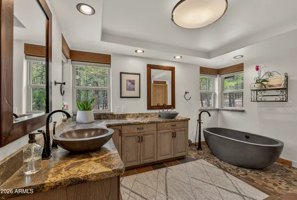 a spacious bathroom with double sink and a mirror