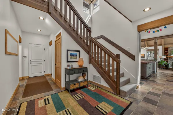 a view of hallway with wooden floor and bedroom
