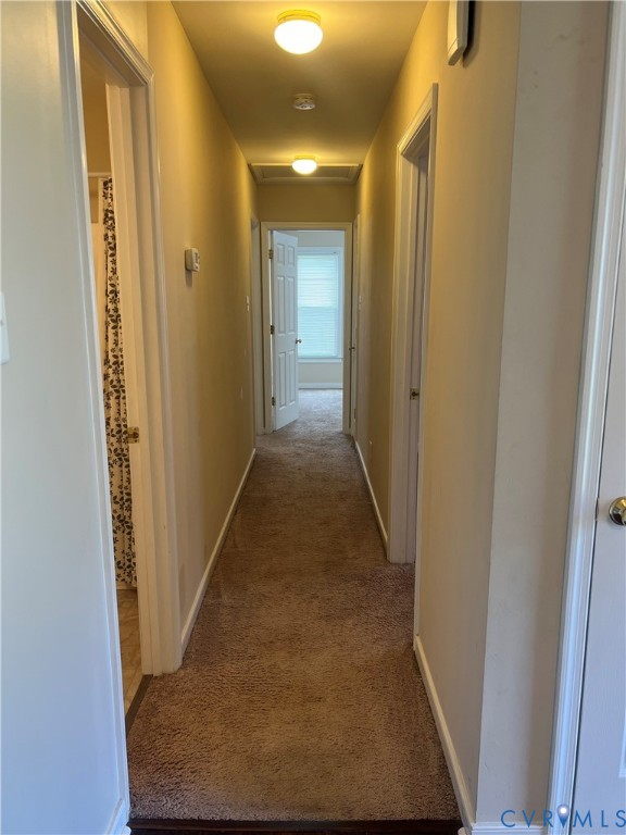 9055 Castle Point Road Glen Allen, VA 23060 - Photo 7 of 19 a view of a hallway with wooden floor and a bathroom