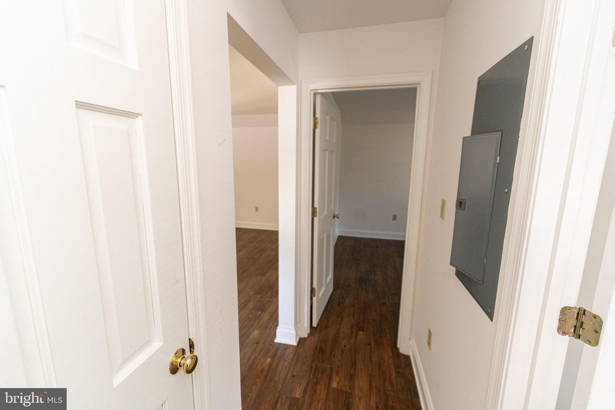 804 Travers Street, Unit 2 Cambridge, MD 21613 - Photo 15 of 26 a view of a hallway with wooden floor and staircase