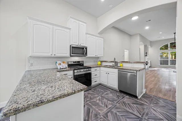 a kitchen with a sink stove and microwave