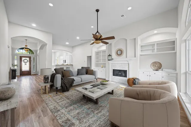 a living room with furniture a fireplace and a flat screen tv