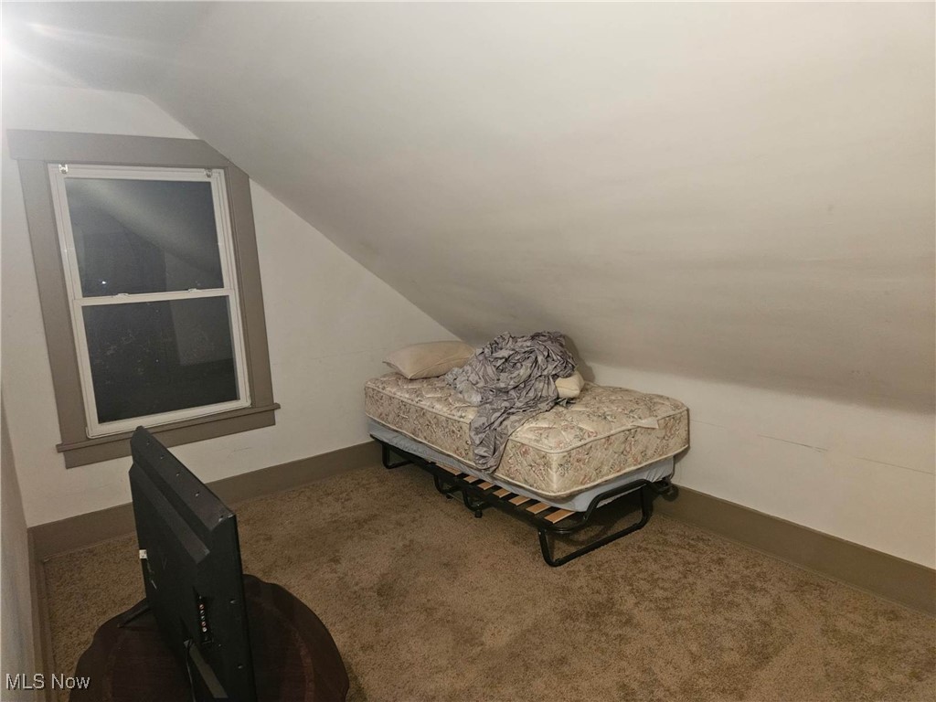 3140 12th Street Northwest Canton, OH 44708 - Photo 10 of 13 Sitting room with vaulted ceiling and dark colored carpet