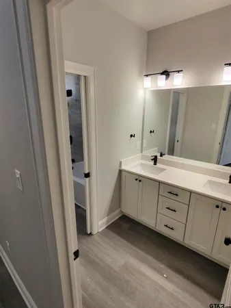 a bathroom with a double vanity sink and mirror