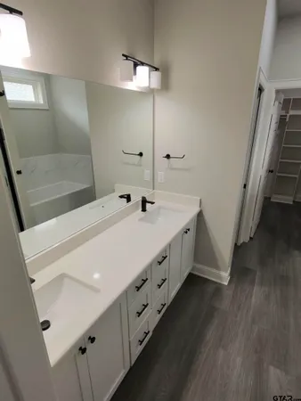 a bathroom with a double vanity sink and mirror