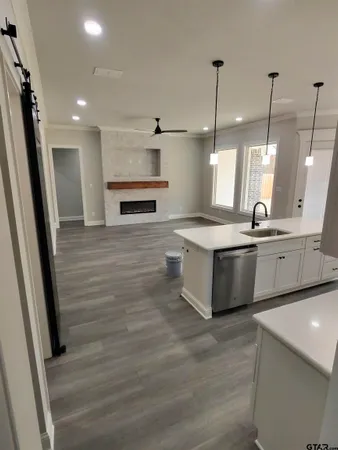 a large white kitchen with a sink a refrigerator and a stove