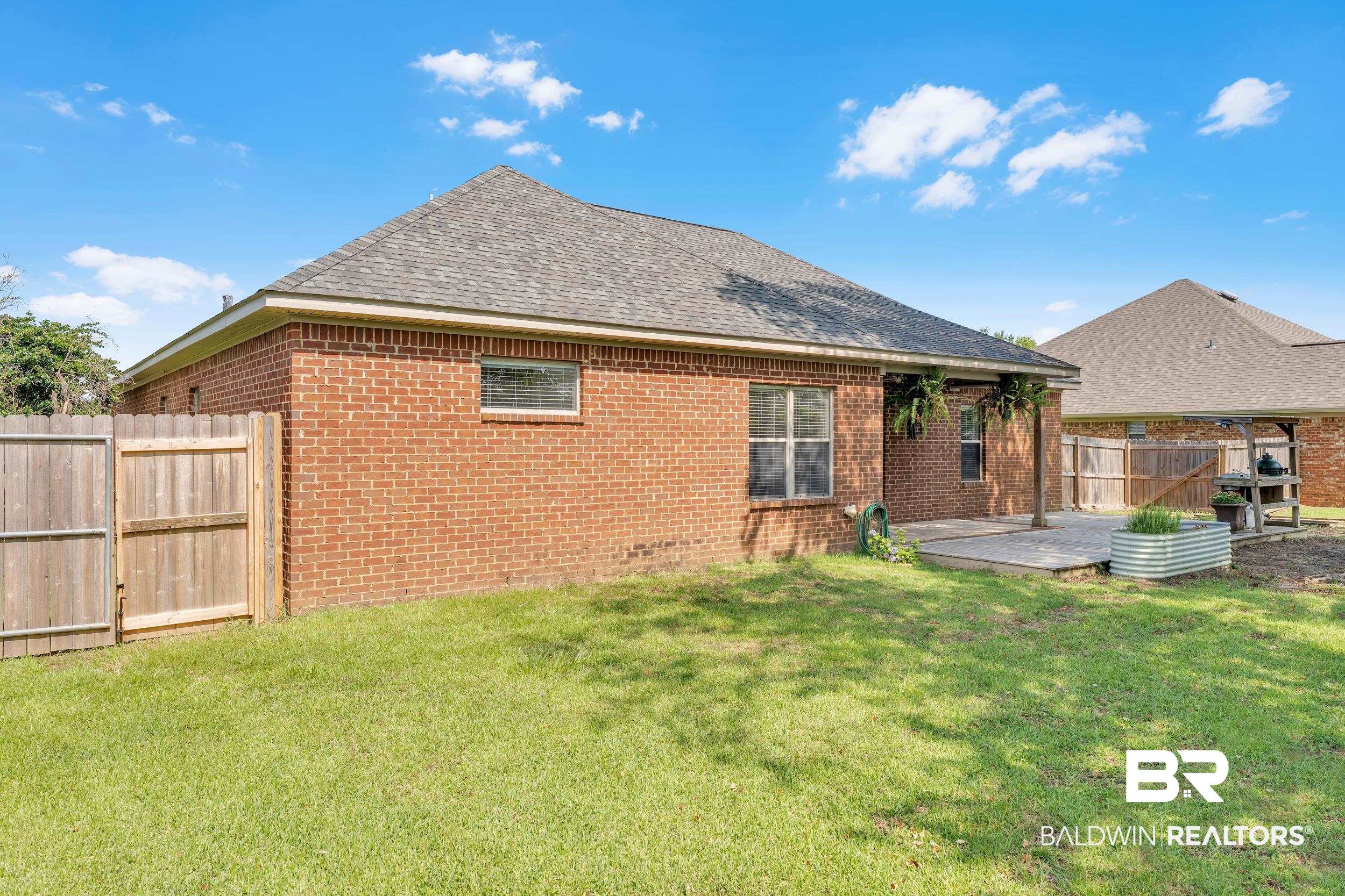 9508 Collier Loop Daphne, AL 36526 - Photo 8 of 29 Rear view of house featuring brick siding, a shingled roof, and a patio area