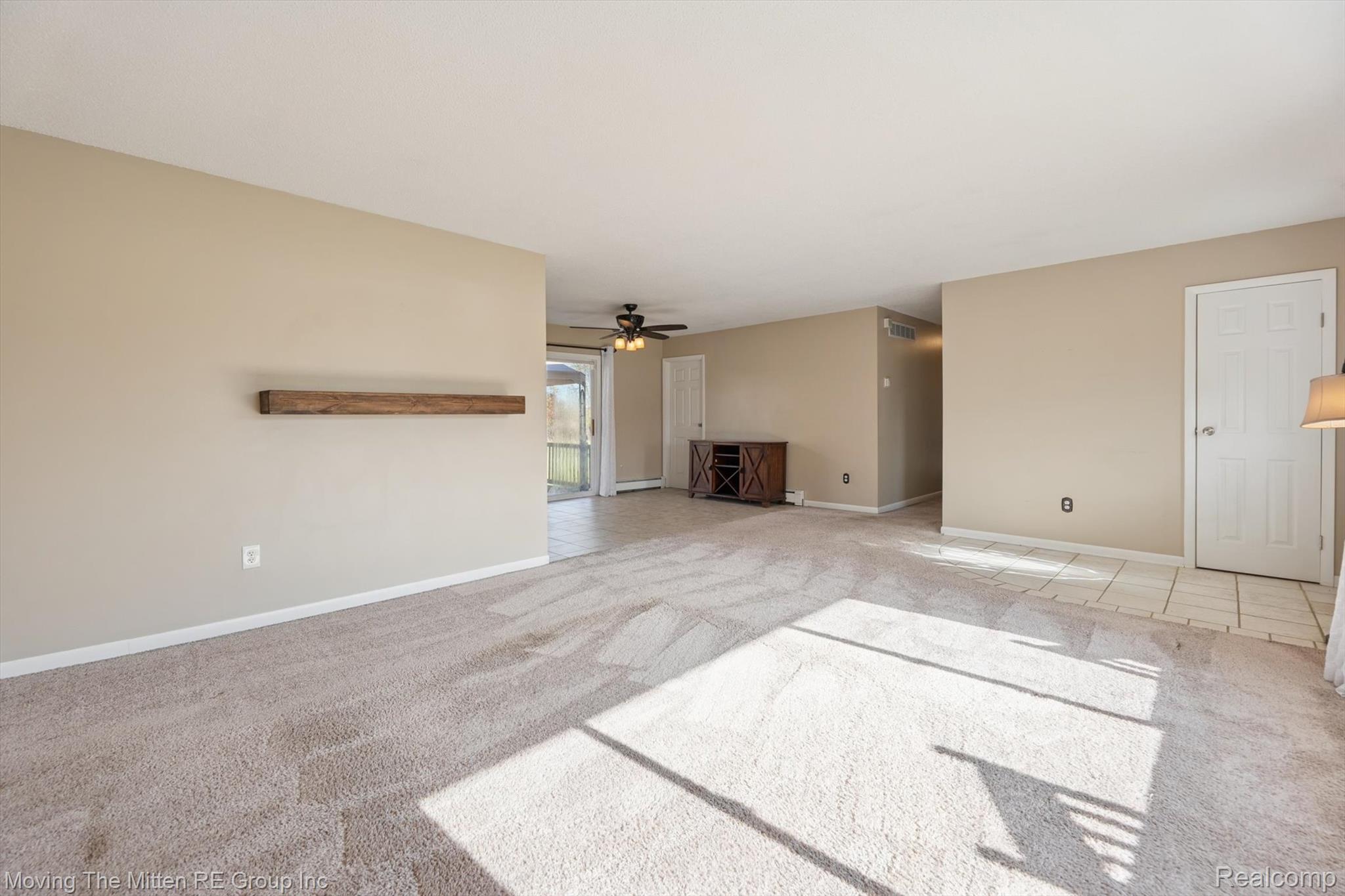 12000 Plank Road Milan, MI 48160 - Photo 7 of 49 Unfurnished living room featuring light carpet and a ceiling fan
