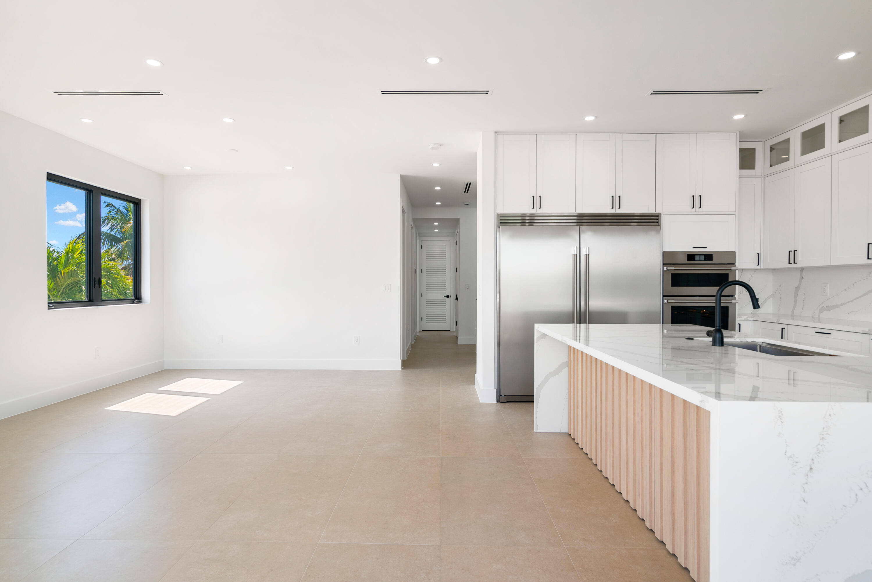 27 Ocean Drive Key Largo, FL 33037 - Photo 11 of 61 a kitchen with stainless steel appliances granite countertop a refrigerator a stove and a sink with wooden floor