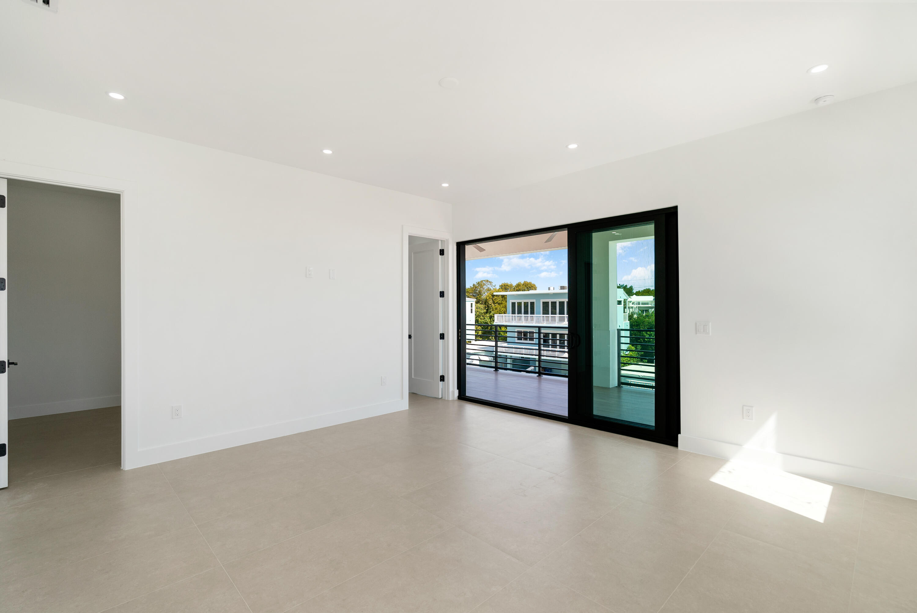 27 Ocean Drive Key Largo, FL 33037 - Photo 30 of 61 an empty room with floor to ceiling window and an outdoor view