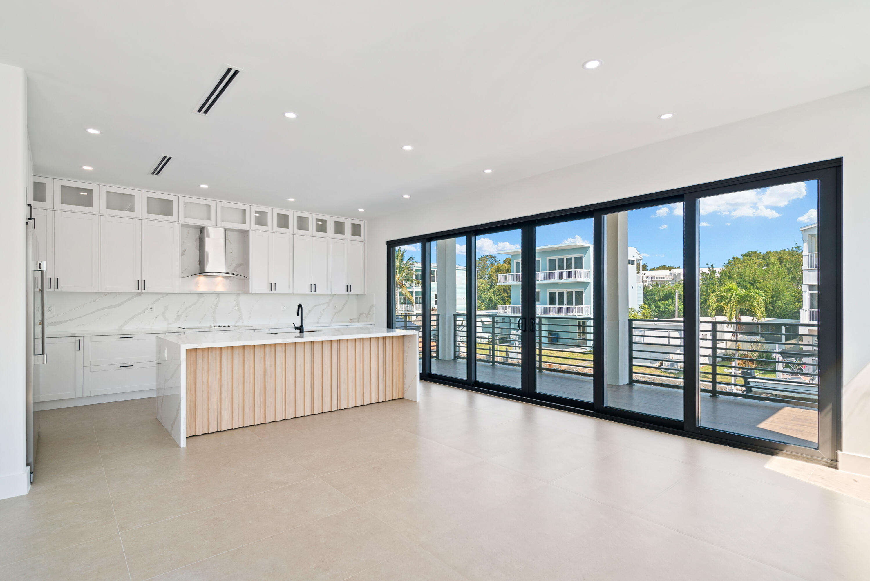 27 Ocean Drive Key Largo, FL 33037 - Photo 7 of 61 a large white room with a large window and stainless steel appliances