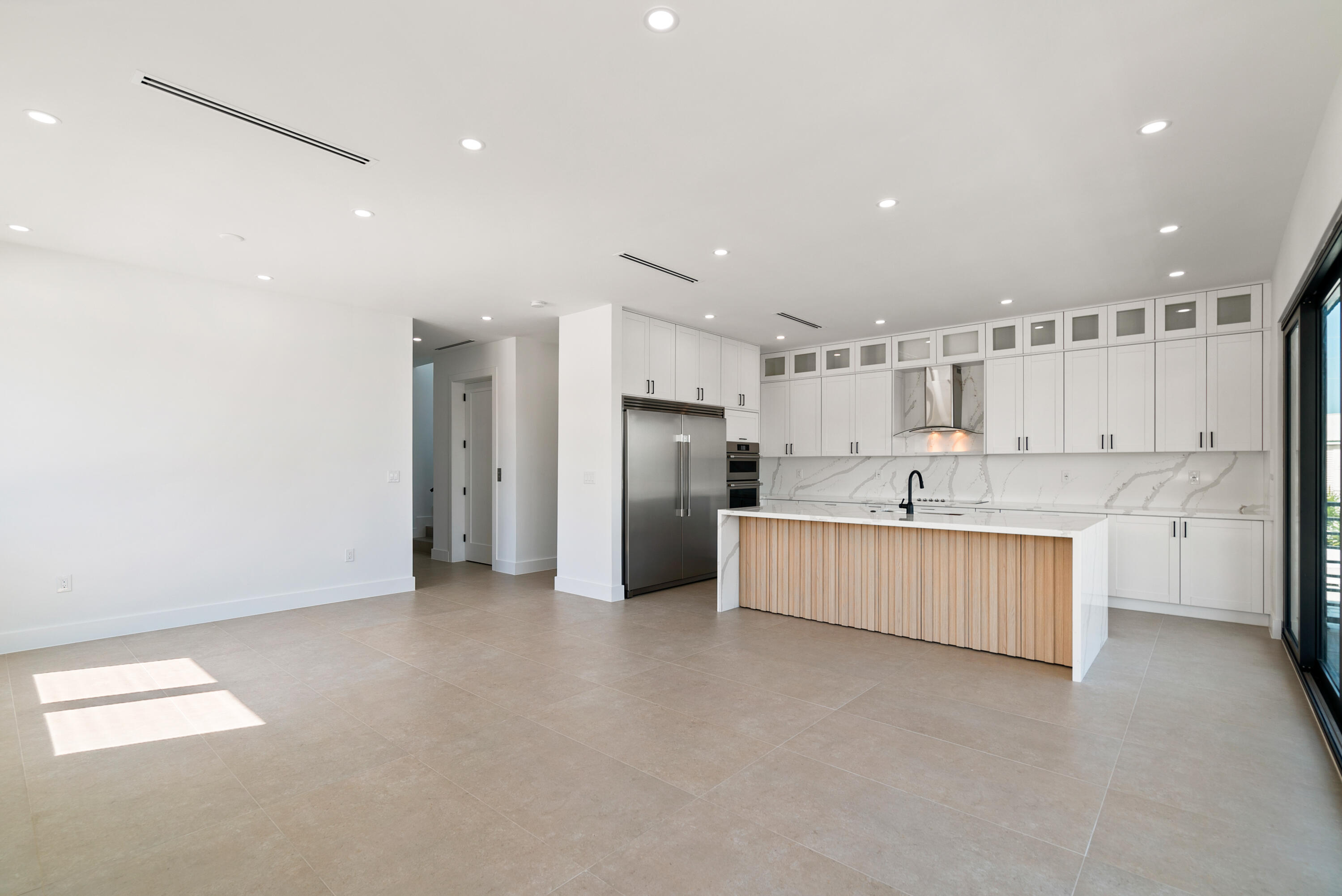 27 Ocean Drive Key Largo, FL 33037 - Photo 10 of 61 a kitchen with stainless steel appliances kitchen island granite countertop a refrigerator and a sink
