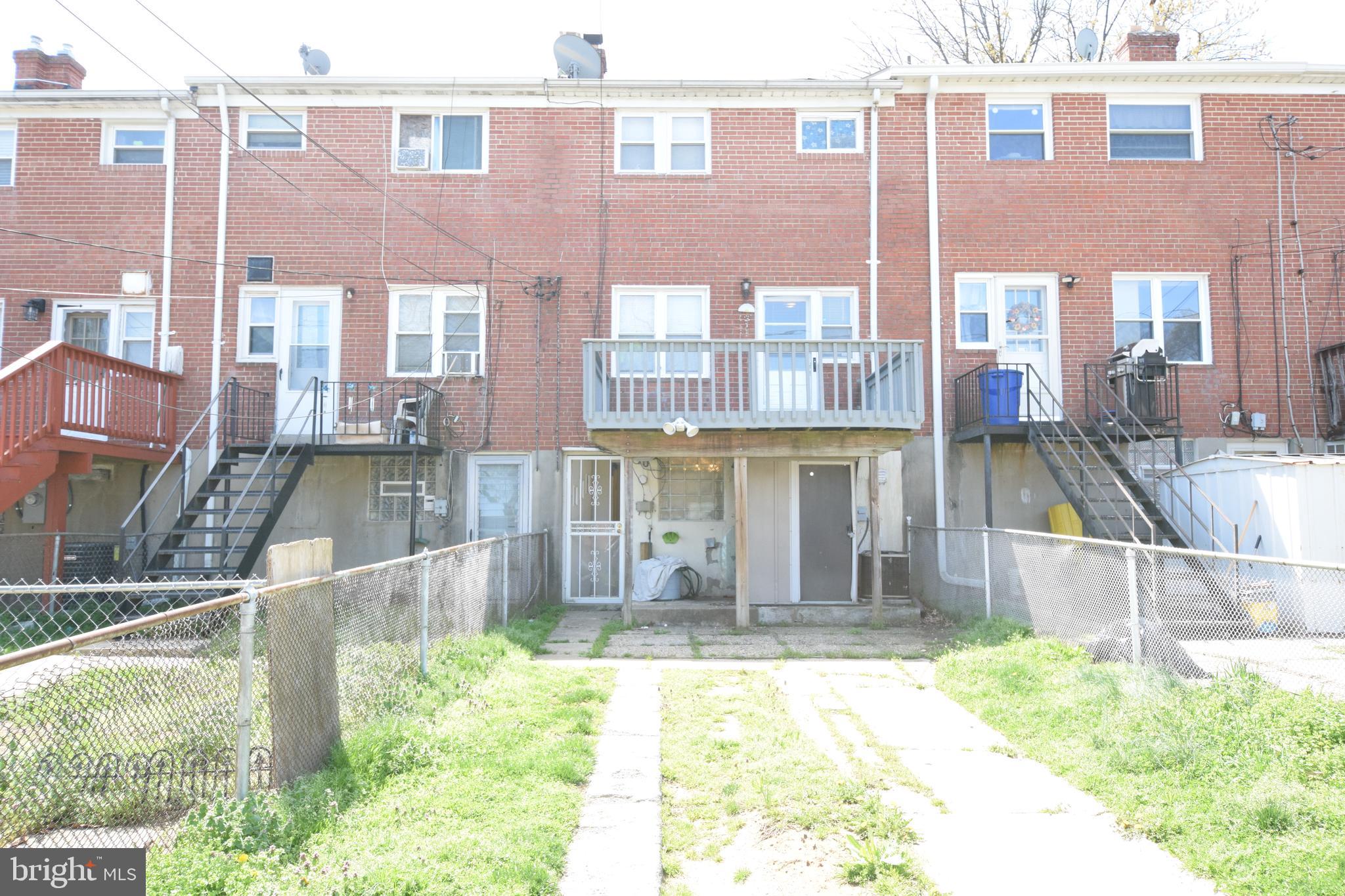 565 Brisbane Road Baltimore, MD 21229 - Photo 11 of 11 a view of a brick building next to a yard