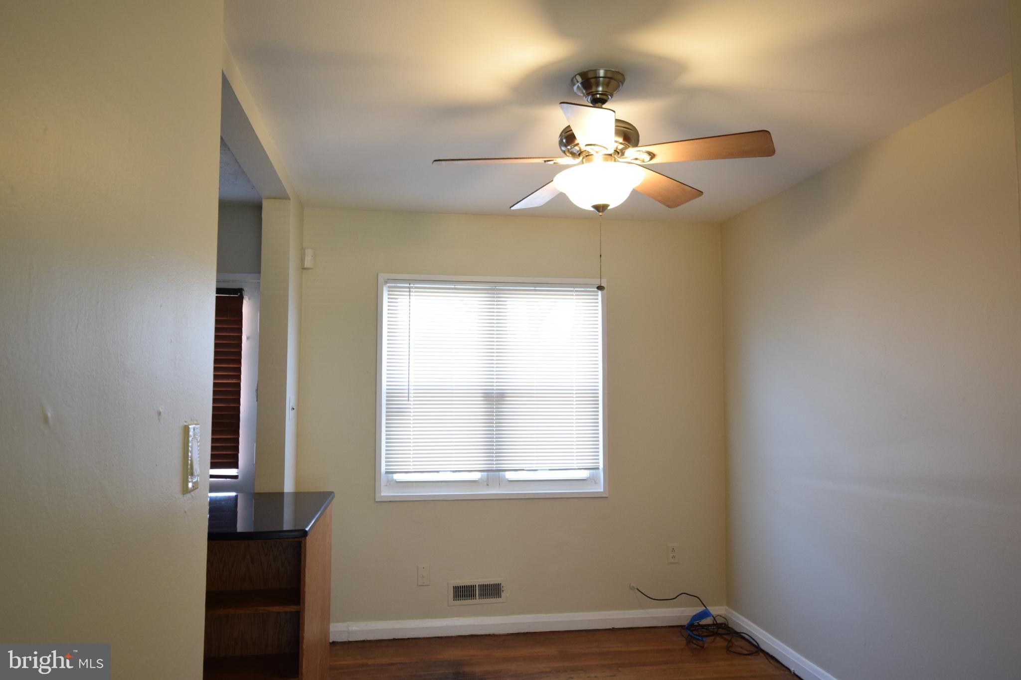 565 Brisbane Road Baltimore, MD 21229 - Photo 3 of 11 a view of a chandelier fan and a window