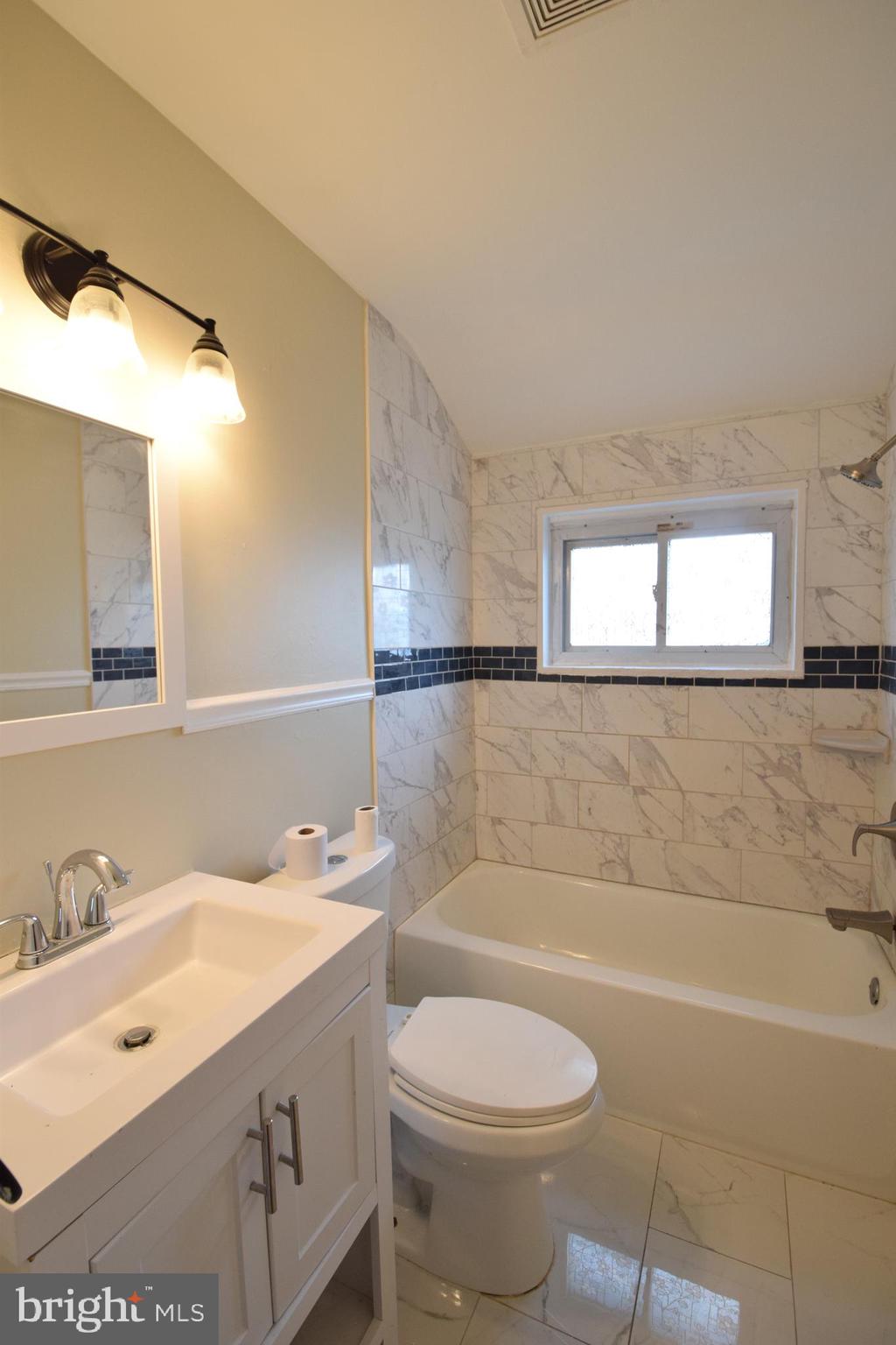 565 Brisbane Road Baltimore, MD 21229 - Photo 6 of 11 a bathroom with a sink a toilet and shower
