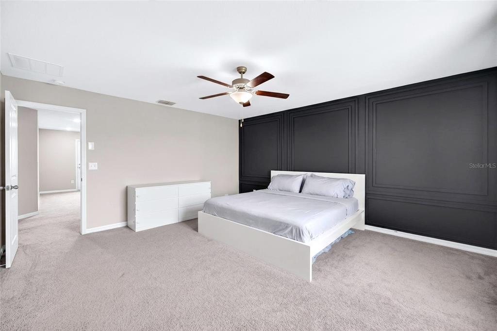 31724 Sun Kettle Loop Wesley Chapel, FL 33545 - Photo 36 of 49 a bedroom with a bed and a ceiling fan