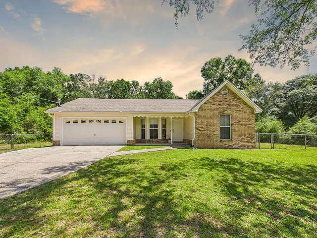 a house with huge green field in front of it