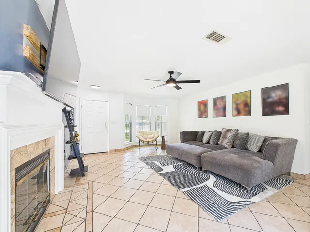 a living room with furniture and a fireplace